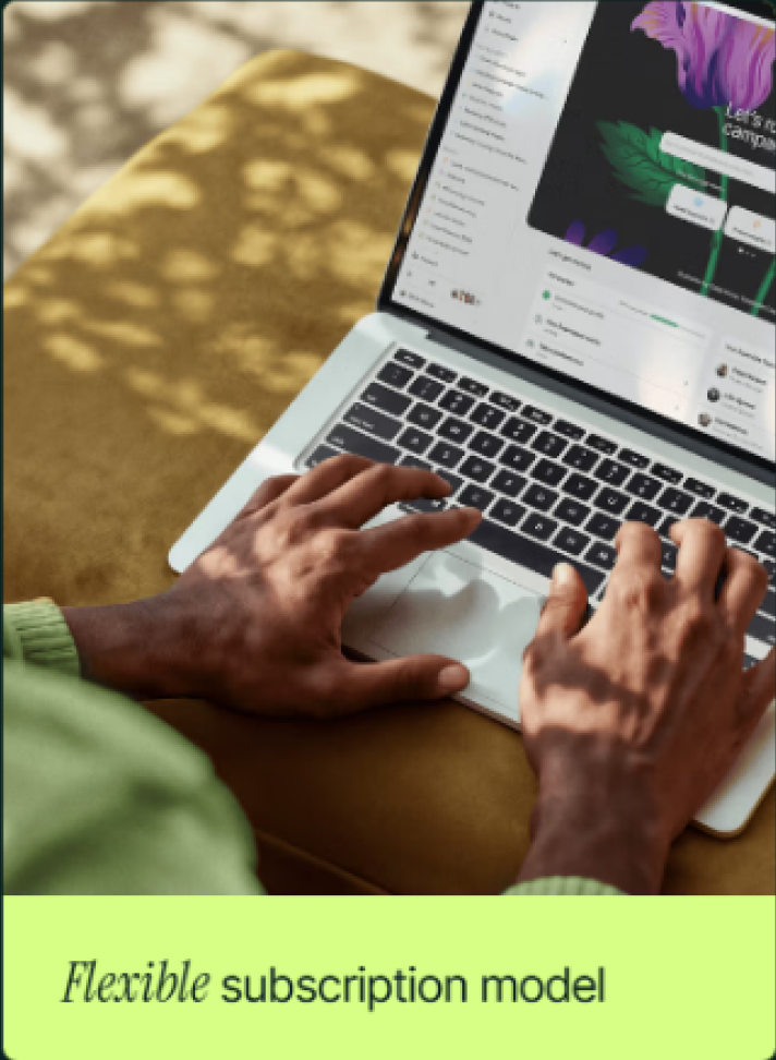 Hands typing on a laptop with a design interface